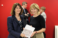 Foto de una persona entregando un informe final a otra.