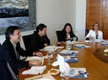 Reunion de trabajo. Grupo de personas debatiendo ante una mesa de reuniones.