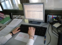 Actividades. Se observan las manos de una administrativa frente al teclado de su ordenador.